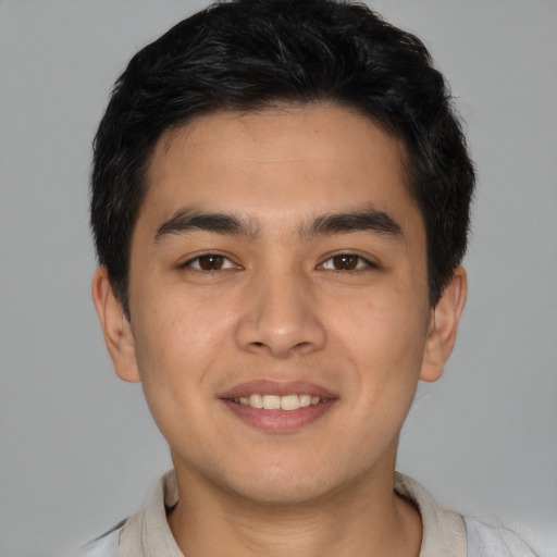Joyful asian young-adult male with short  brown hair and brown eyes