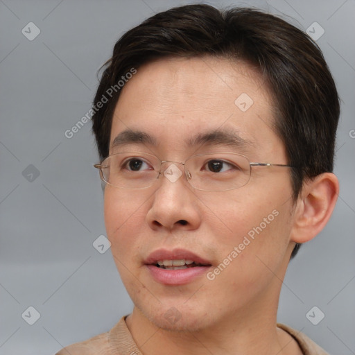 Joyful asian young-adult male with short  brown hair and brown eyes