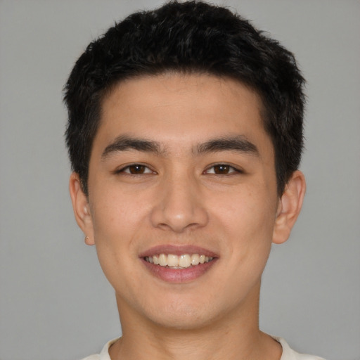 Joyful white young-adult male with short  black hair and brown eyes