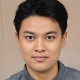 Joyful asian young-adult male with short  black hair and brown eyes