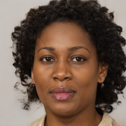 Joyful black adult female with medium  brown hair and brown eyes