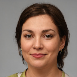 Joyful white adult female with medium  brown hair and brown eyes