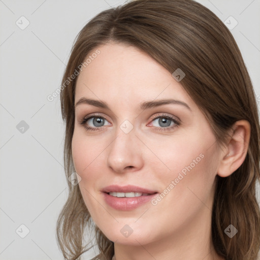 Joyful white young-adult female with long  brown hair and blue eyes