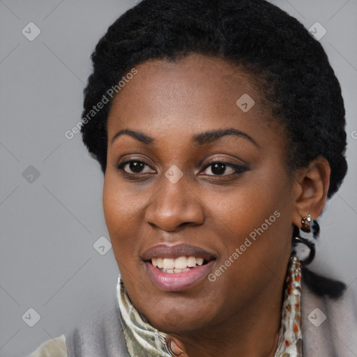 Joyful black young-adult female with short  black hair and brown eyes