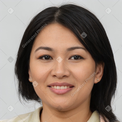 Joyful asian adult female with medium  brown hair and brown eyes