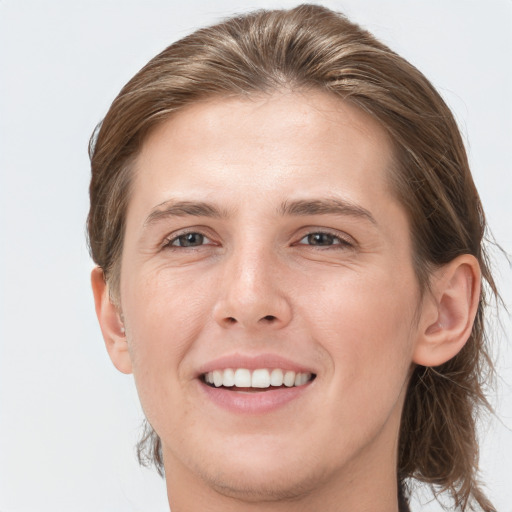 Joyful white young-adult female with long  brown hair and grey eyes