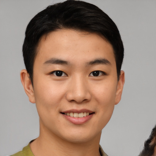 Joyful asian young-adult male with short  brown hair and brown eyes