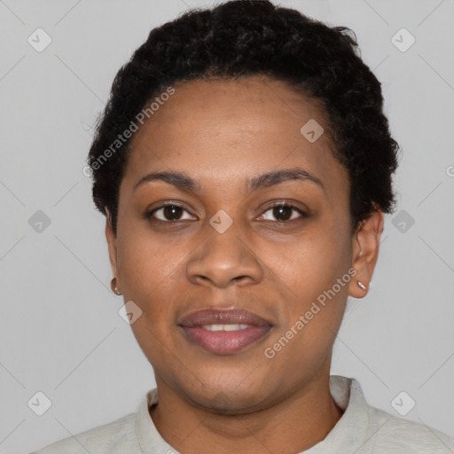 Joyful black young-adult female with short  black hair and brown eyes