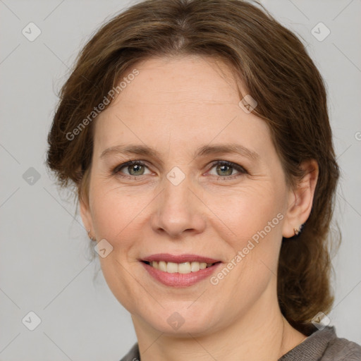 Joyful white adult female with medium  brown hair and grey eyes