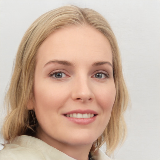 Joyful white young-adult female with medium  brown hair and blue eyes