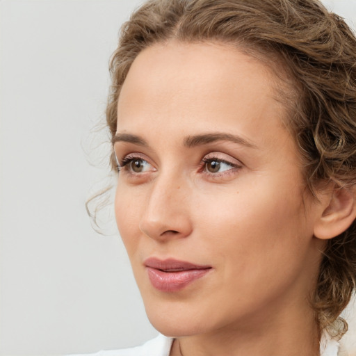 Joyful white young-adult female with medium  brown hair and green eyes