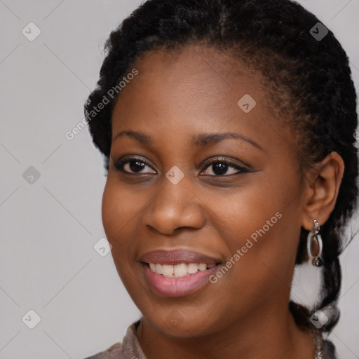 Joyful black young-adult female with medium  black hair and brown eyes