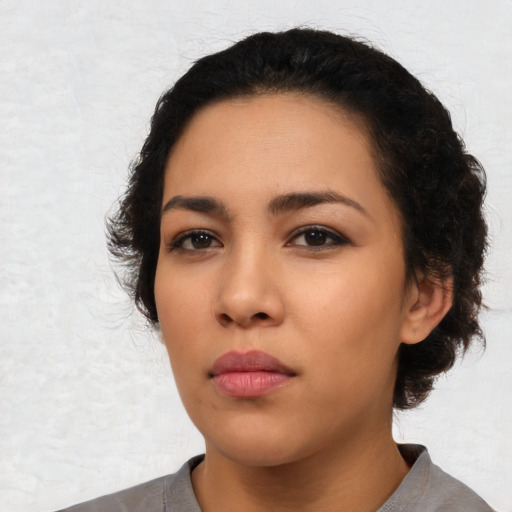 Neutral latino young-adult female with medium  black hair and brown eyes