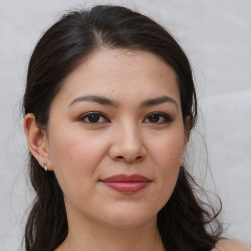 Joyful white young-adult female with long  brown hair and brown eyes