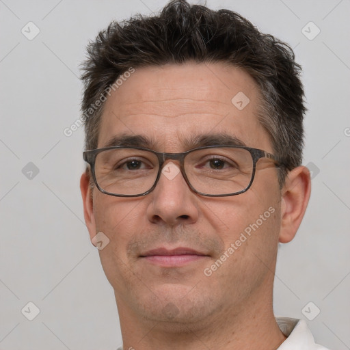 Joyful white adult male with short  brown hair and brown eyes