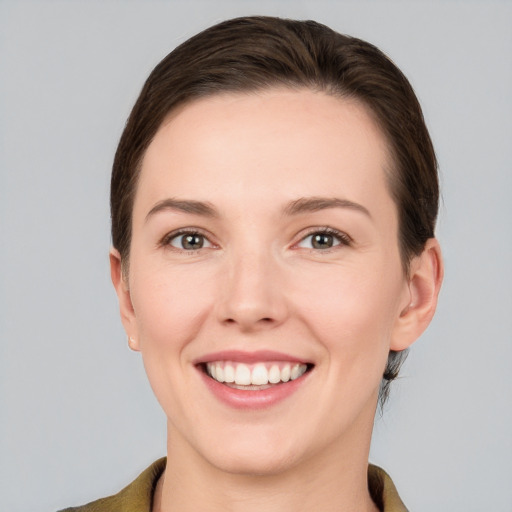 Joyful white young-adult female with short  brown hair and grey eyes