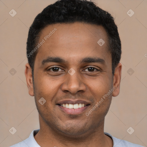 Joyful latino young-adult male with short  black hair and brown eyes