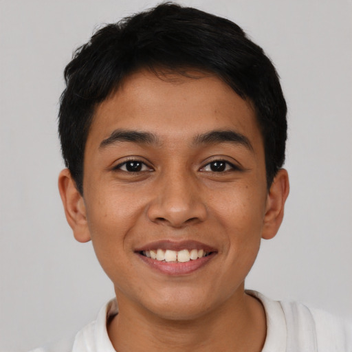 Joyful latino young-adult male with short  brown hair and brown eyes