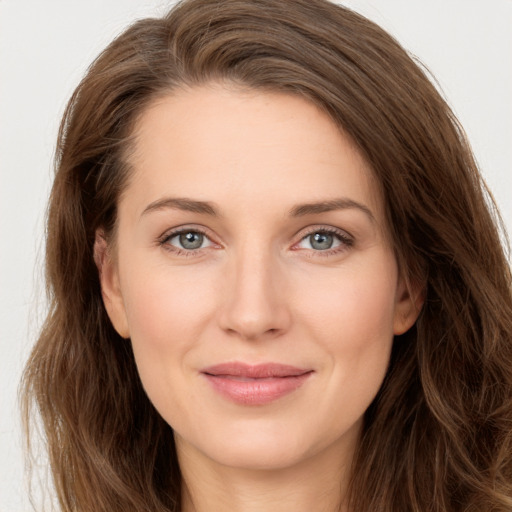 Joyful white young-adult female with long  brown hair and green eyes