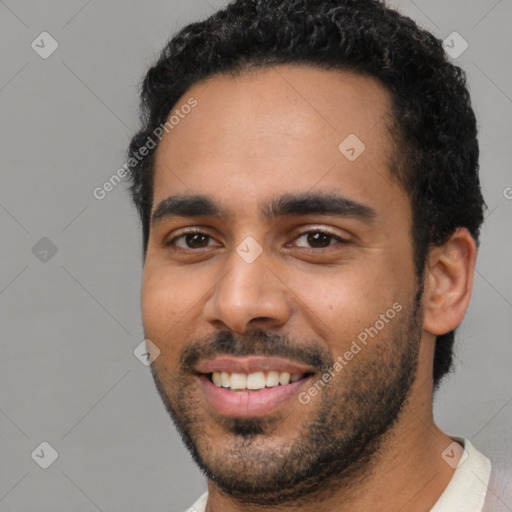 Joyful latino young-adult male with short  black hair and brown eyes