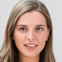 Joyful white young-adult female with long  brown hair and blue eyes