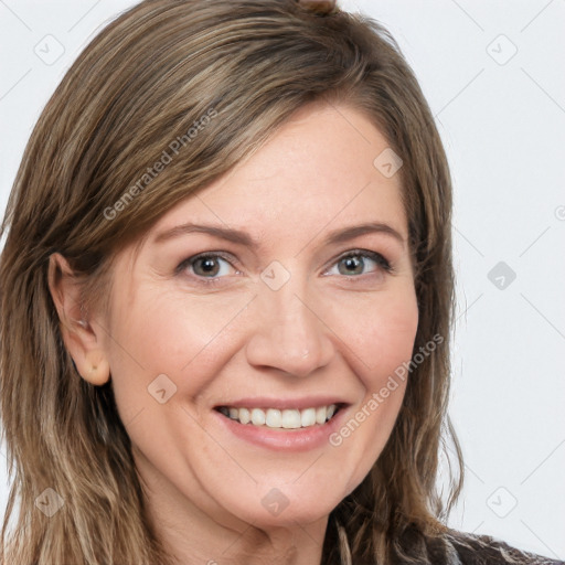 Joyful white adult female with long  brown hair and grey eyes