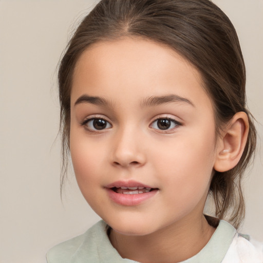 Joyful white child female with medium  brown hair and brown eyes