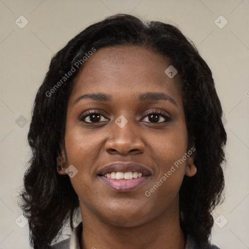 Joyful black young-adult female with long  black hair and brown eyes