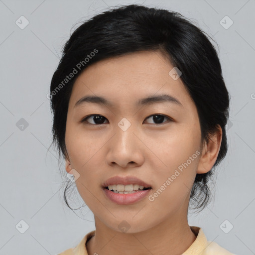 Joyful asian young-adult female with medium  black hair and brown eyes