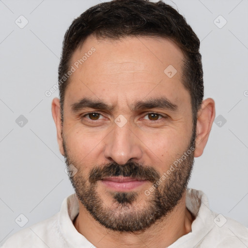 Joyful white adult male with short  brown hair and brown eyes