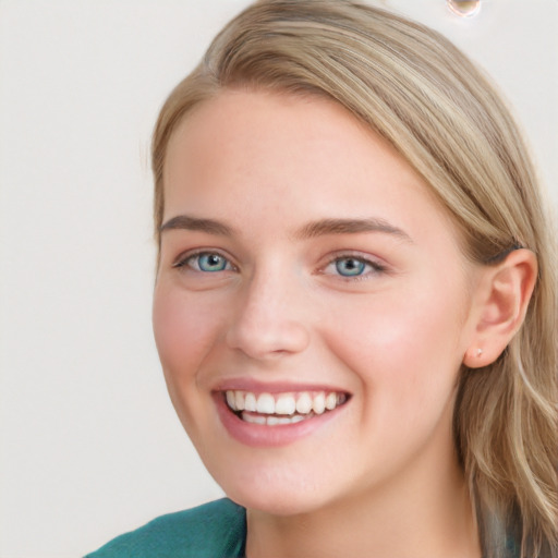 Joyful white young-adult female with long  brown hair and blue eyes