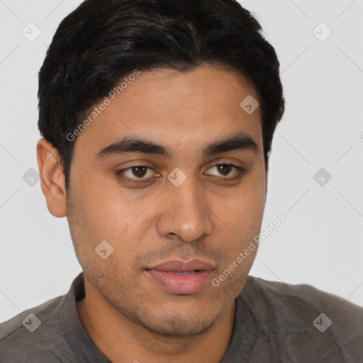 Joyful latino young-adult male with short  brown hair and brown eyes