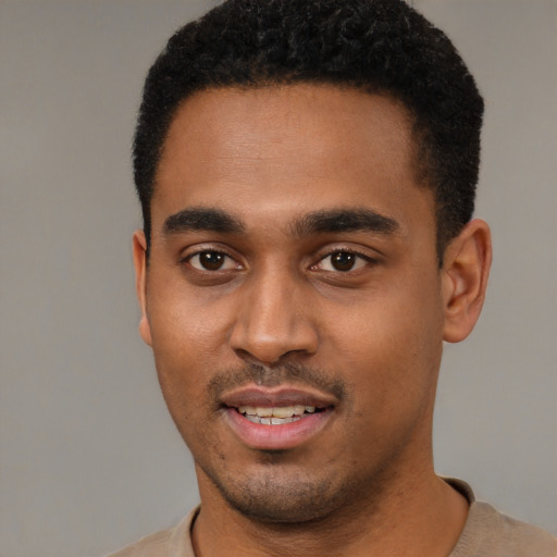 Joyful black young-adult male with short  black hair and brown eyes