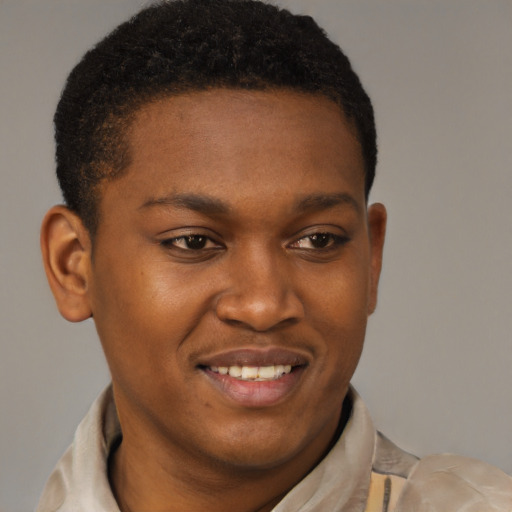 Joyful black young-adult male with short  brown hair and brown eyes
