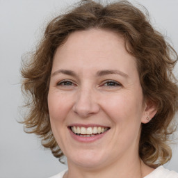 Joyful white adult female with medium  brown hair and brown eyes