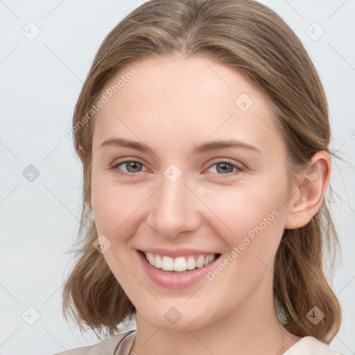 Joyful white young-adult female with medium  brown hair and blue eyes