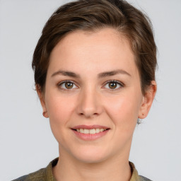 Joyful white young-adult female with short  brown hair and grey eyes