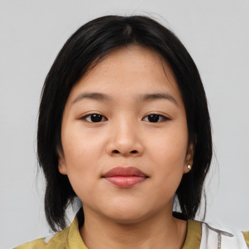 Joyful asian child female with medium  black hair and brown eyes