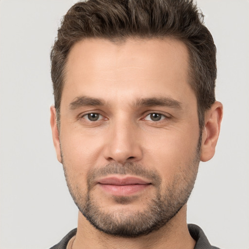 Joyful white young-adult male with short  brown hair and brown eyes