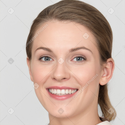 Joyful white young-adult female with medium  brown hair and blue eyes