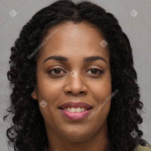 Joyful black young-adult female with long  brown hair and brown eyes