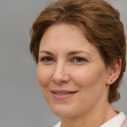 Joyful white adult female with short  brown hair and brown eyes