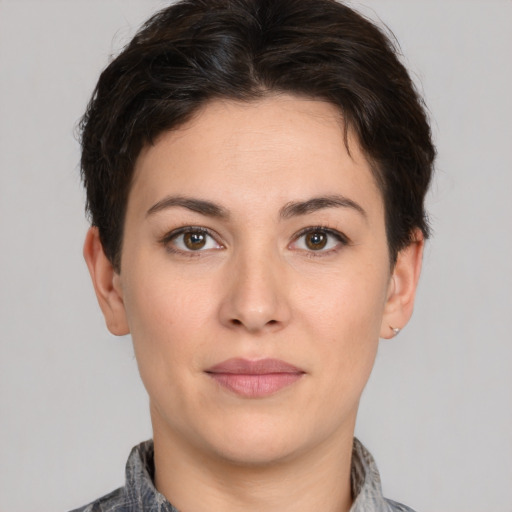 Joyful white young-adult female with short  brown hair and brown eyes
