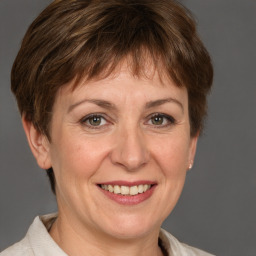 Joyful white adult female with short  brown hair and grey eyes