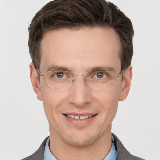 Joyful white adult male with short  brown hair and grey eyes