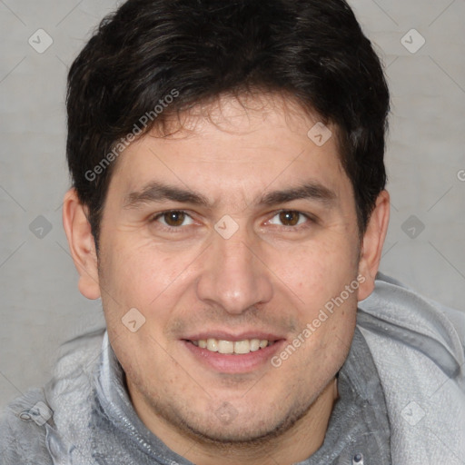 Joyful white adult male with short  brown hair and brown eyes