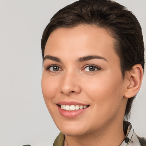 Joyful white young-adult female with medium  brown hair and brown eyes