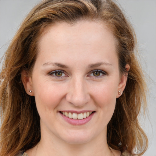 Joyful white young-adult female with long  brown hair and blue eyes