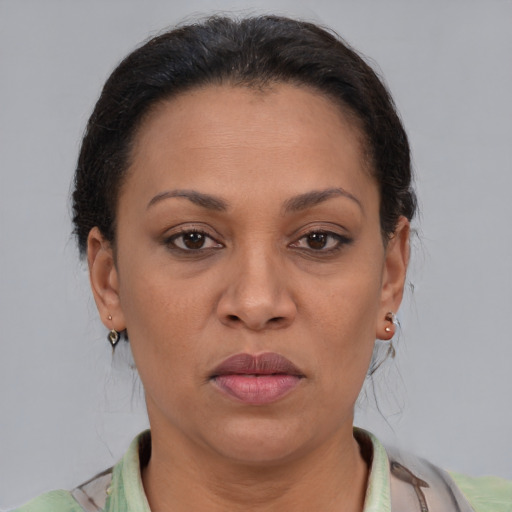 Joyful latino adult female with short  brown hair and brown eyes