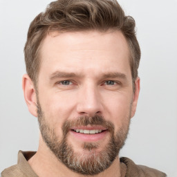 Joyful white adult male with short  brown hair and grey eyes